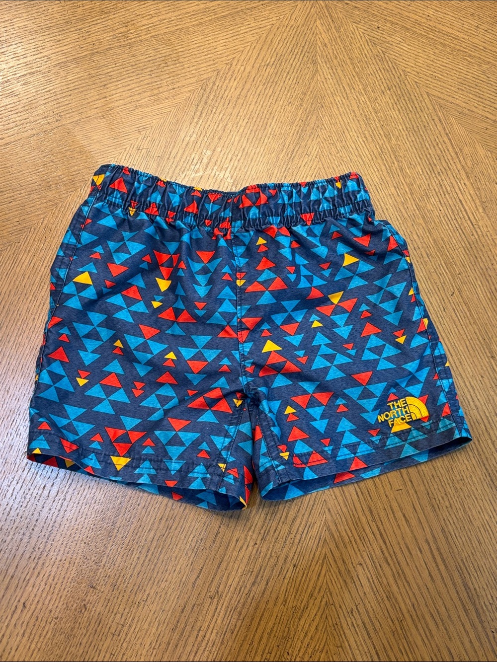 The North Face Kids Blue Triangle Print Shorts with Red & Yellow Accents